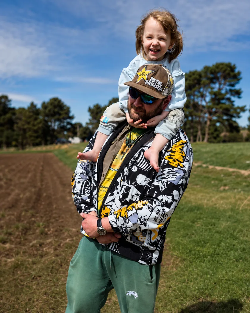 Preston Winters with his daughter outdoors in Bandon, Oregon.